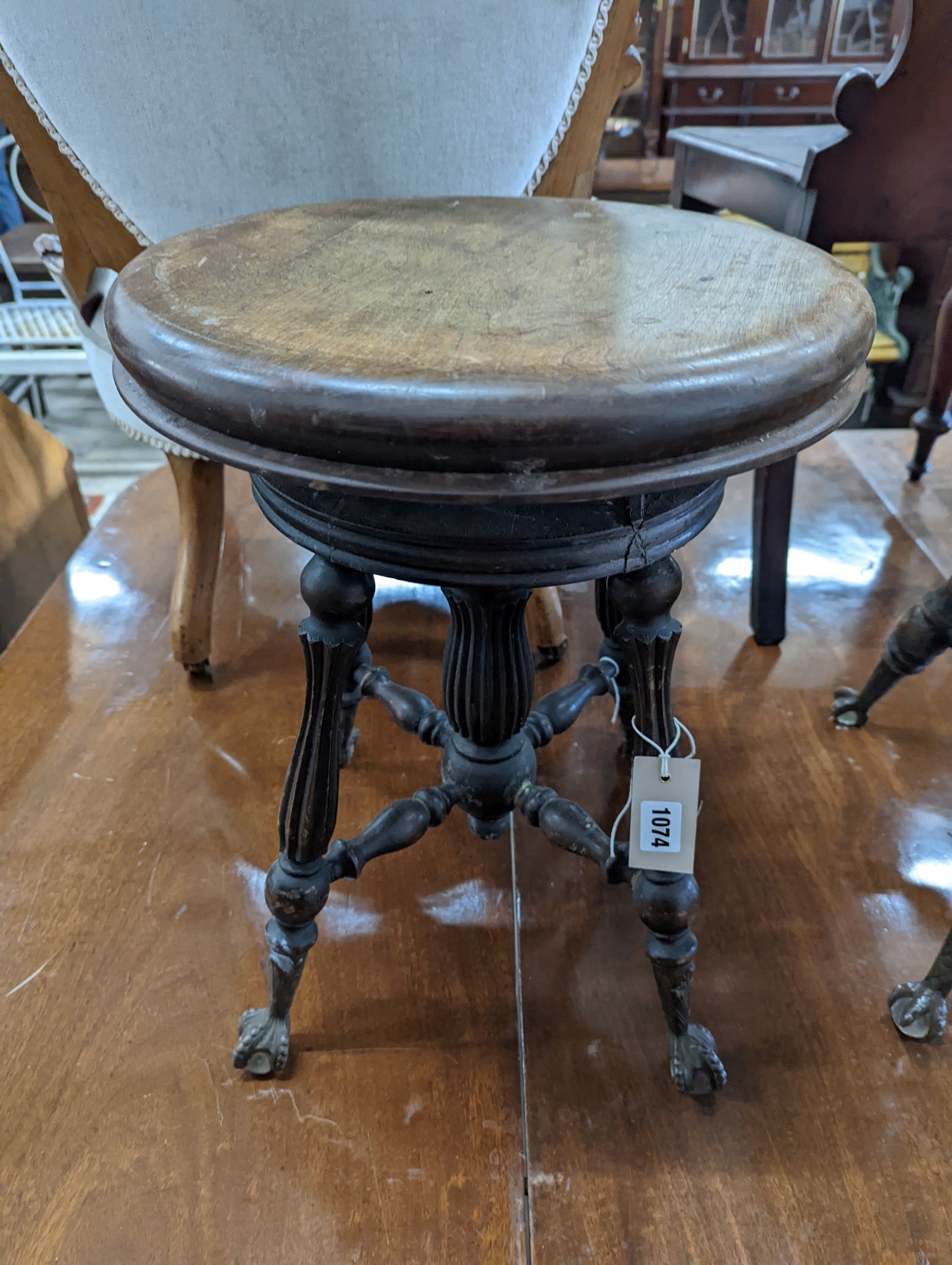 A near pair of Victorian mahogany and beech adjustable stools with revolving seats, larger diameter 36cm